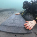 Mortar Wreck diver looking at decorated gravestone