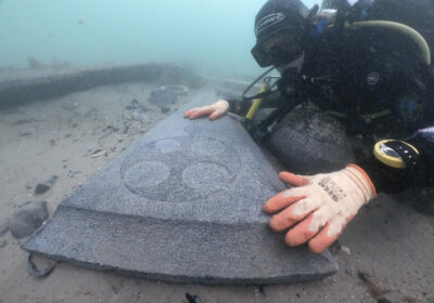 Mortar Wreck diver looking at decorated gravestone