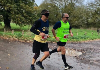 Cliffe Tribe runs with a blindfold guided by John Baker in honour of their friend David Edwards