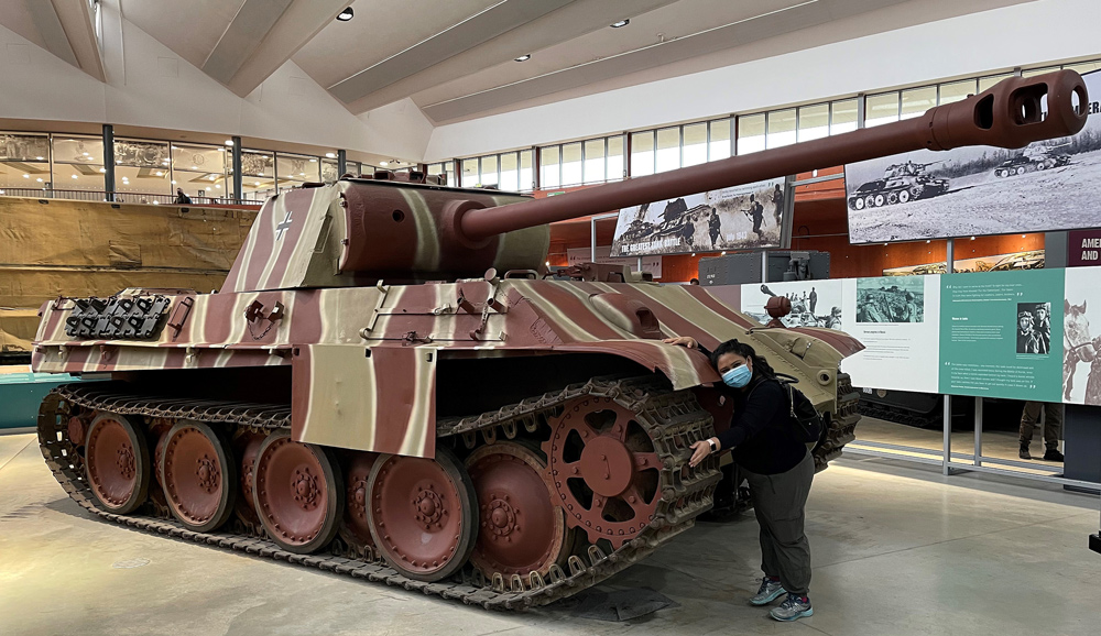 Bake Off winner Syabira Yusoff hugging a Panther at the Tank Museum in Bovington