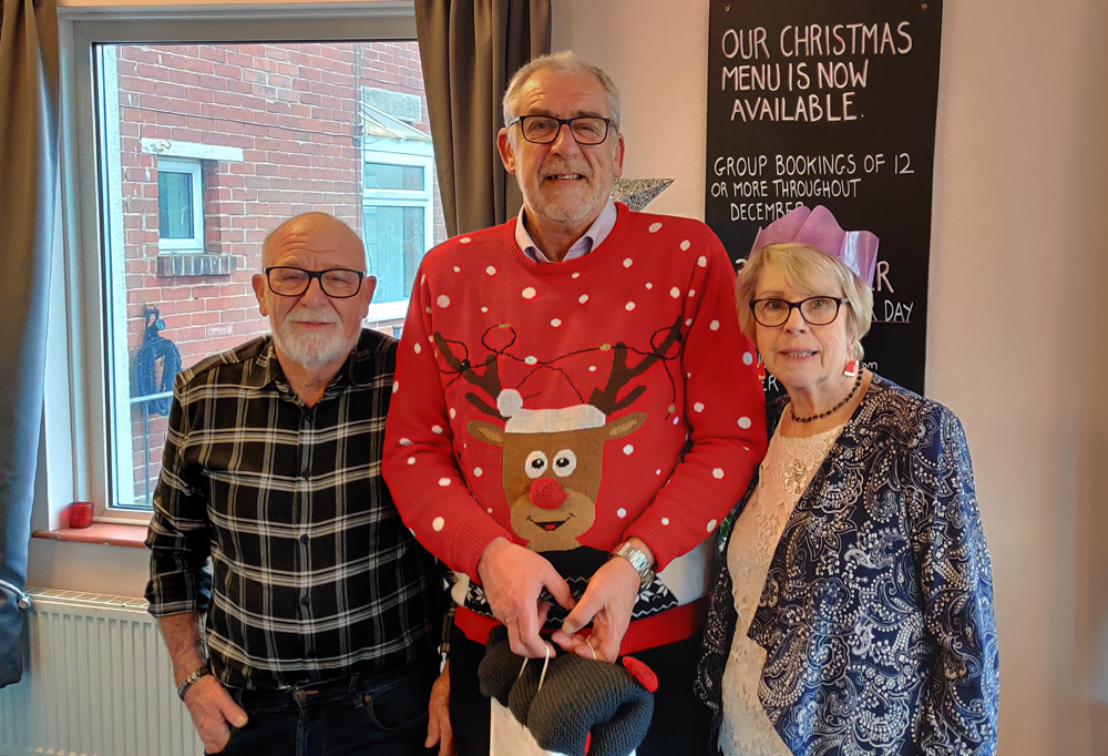 Swanage residents and Eat and Meet organisers Roy and Norma Hoppe (left and right) with Steve Churchill representing Heroes Haven