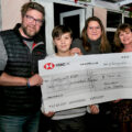 Brewers Arms, Martinstown, owners Leanne and Ben Carter with one of their sons and Roelie Newman, from Martinstown Circle Suppers, holding the cheque for £7,000 raised for Living with CAH.