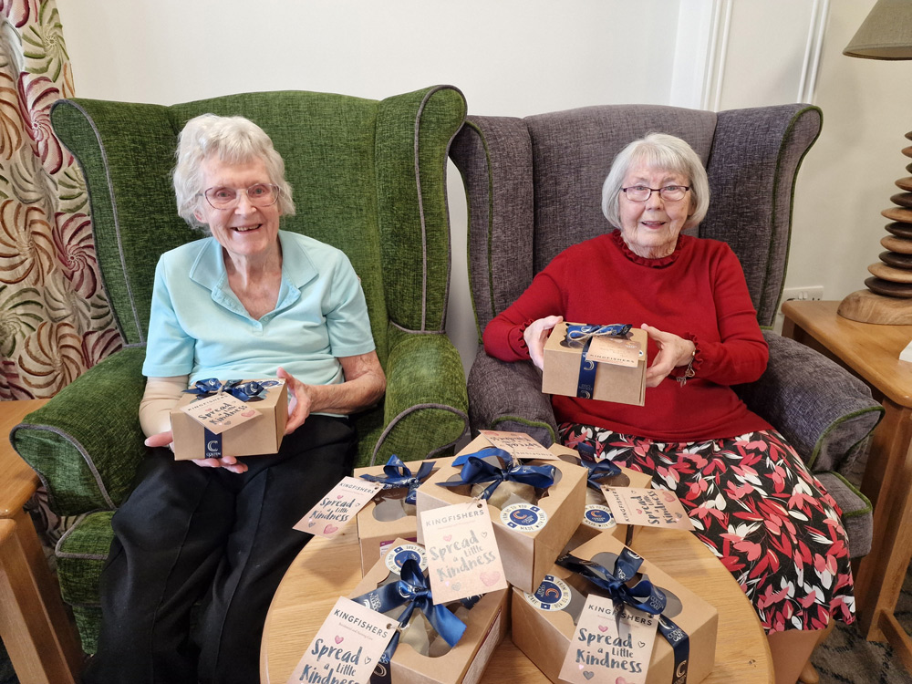 Kingfishers residents June Price, left, and Val Collinge with boxes of shortbread ready to distribute to community contacts.