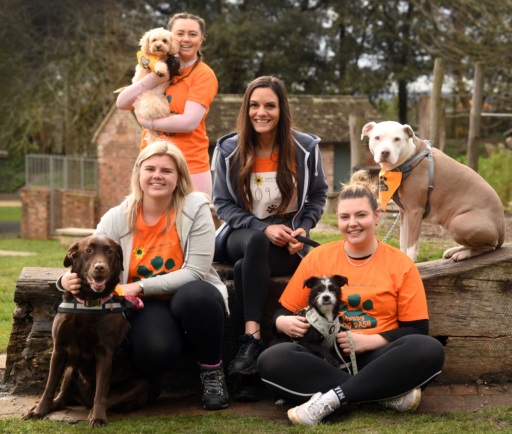 The Ellis Jones team picture with their dogs are, from left, Paige Abbott with Maddie, Jessica Khelifi with Molly (standing up), Raluca Parker with Lucy and Daisy Kershaw with Poppy