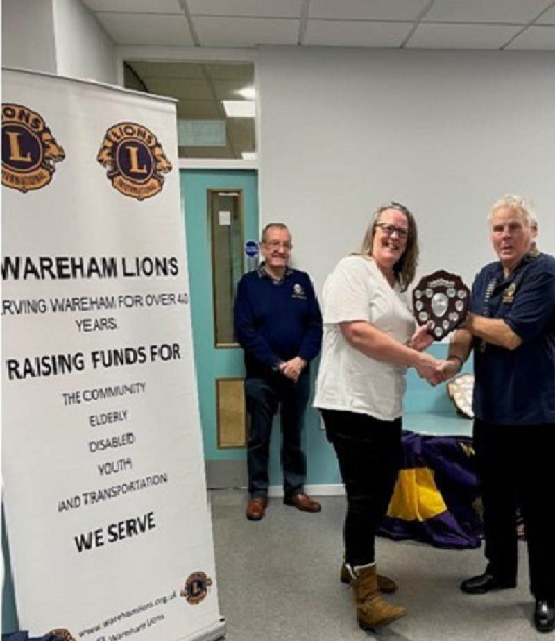 Richard Weaver, of Wareham Lions, presented a plaque given to the team raising the most money in the Lions’ annual Swim for Charity event – to Helen Casey, treasurer of the Allison Campbell Trust, during a celebration at the Purbeck Allstars Sports Bar