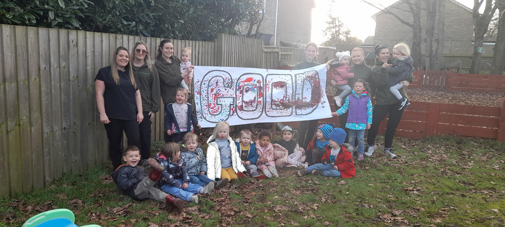 Staff and children celebrate at Tops Corfe Mullen