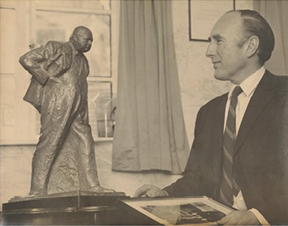 Sir Langford-Holt admiring the bronze maquette of Sir Winston Churchill