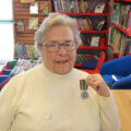 Eileen Osgood shows off her Long Service Medal