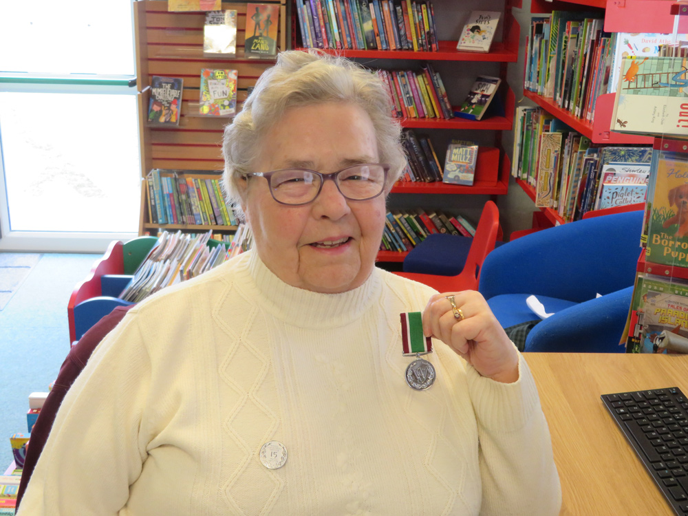 Eileen Osgood shows off her Long Service Medal