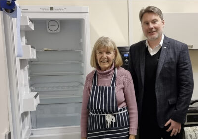 Matt Renaut, managing director of Dacombes in Wimborne, presents the new fridge freezer to Elizabeth Barge, volunteer cook at Wimborne Community Food Supply