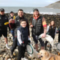Chris Payne and Oly Rush with Green Folk staff and family during a Dorset beach clean
