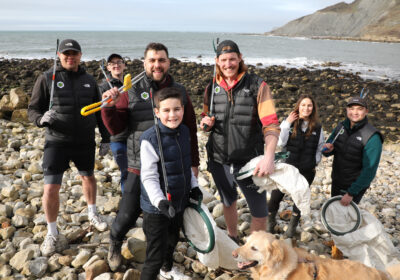 Chris Payne and Oly Rush with Green Folk staff and family during a Dorset beach clean