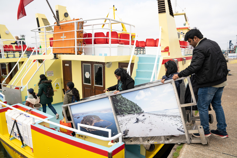 Family visitors board the Brownsea ferry.