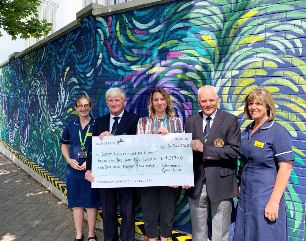 Weymouth Golf Club captains Simon Etherington, second left, and Pat Crane, second right, with Vicki Kingston, DCH Charity fundraising administrator, centre, and members of the Fortuneswell Ward and Paediatric Diabetes teams