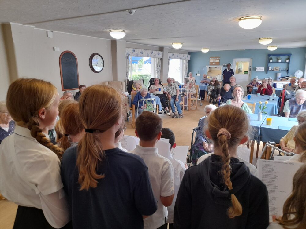 Hamworthy Park Junior School youngsters singing at Dorset House