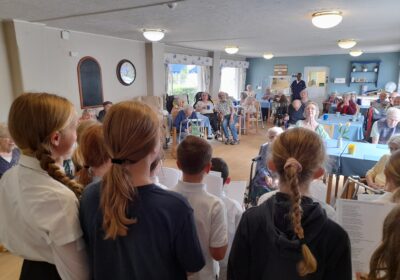 Hamworthy Park Junior School youngsters singing at Dorset House