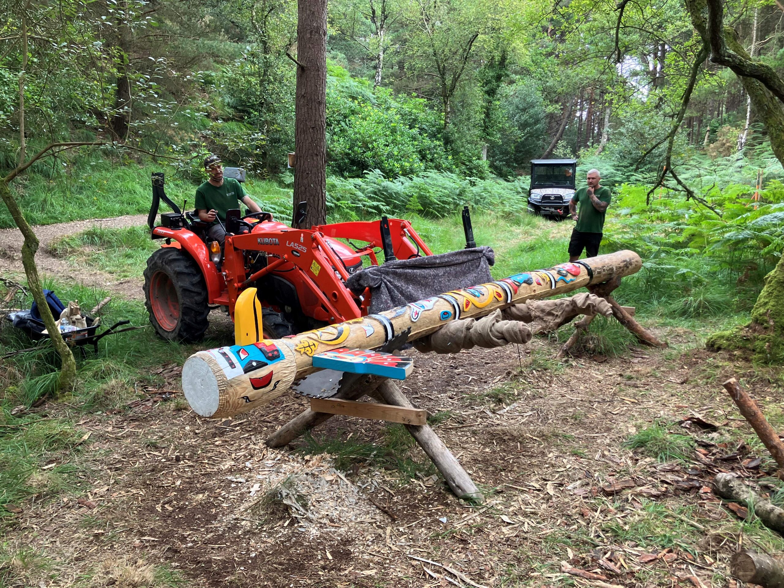 The totem pole being lifted into place...