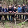 Members of the Men's Shed team with the log used to create a totem pole