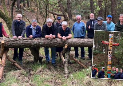 Members of the Men's Shed group with the log that became the amazing totem pole, inset