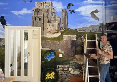 Artful Ranger Mark Newton working on the mural at Corfe Castle. Picture: National Trust/Mark Newton