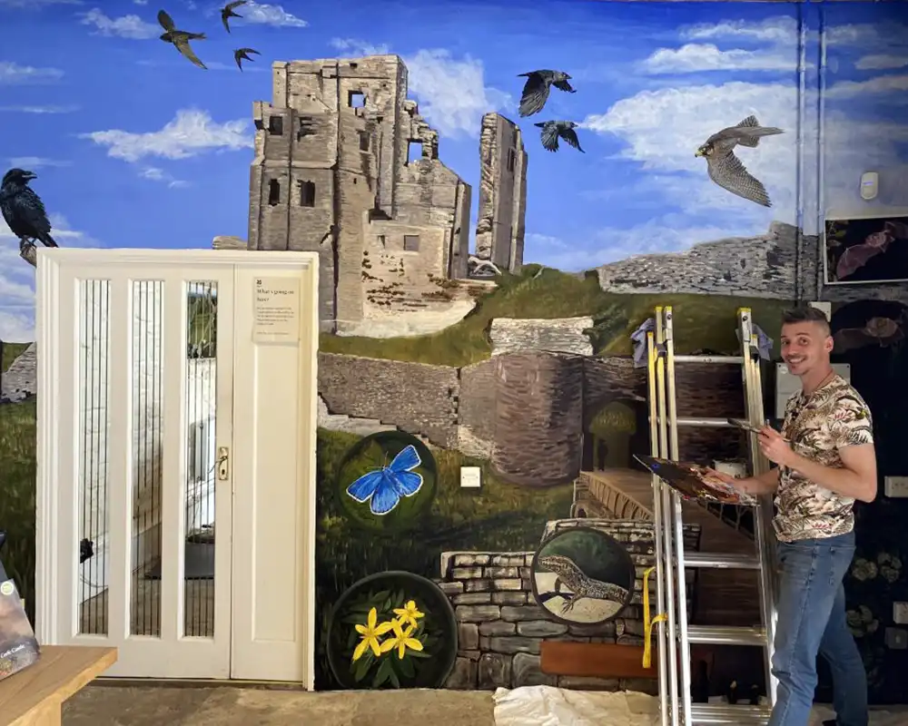 Artful Ranger Mark Newton working on the mural at Corfe Castle. Picture: National Trust/Mark Newton
