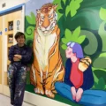 Marina Renee-Cemmick with her Mural on Kingfisher Ward