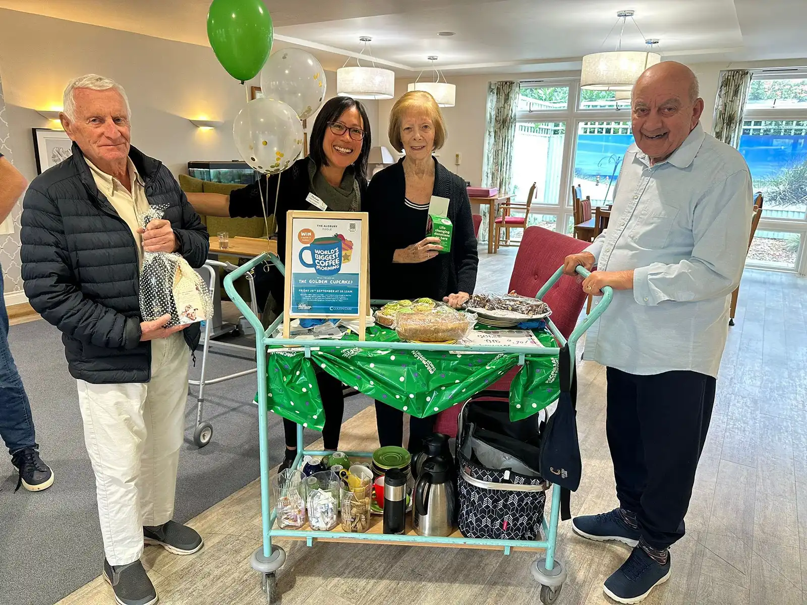 With the fundraising cake trolley at The Aldbury are, from left: resident Gren Braybrook, Companionship Team member Melissa Siat Caparros and residents Joan Perrin and Abdu ‘Hobi’ Sabih