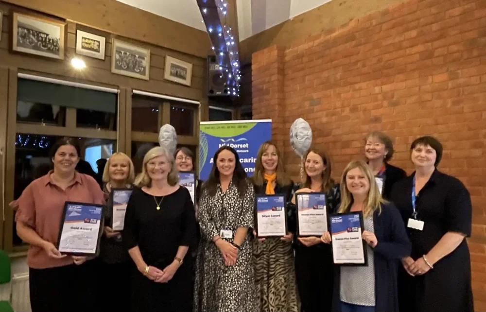 Carers leads and GP practice representatives who were recognised at the event pictured alongside carer Christine Carter, and Harriet Stevens, BCFC project lead and carers engagement facilitator