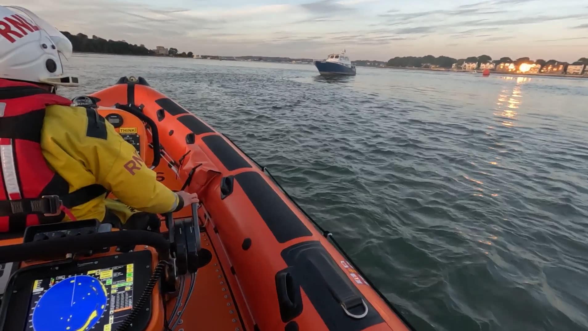 The RNLI lifeboat crew rescuing a flooding boat from Poole Harbour. Photo: RNLI.