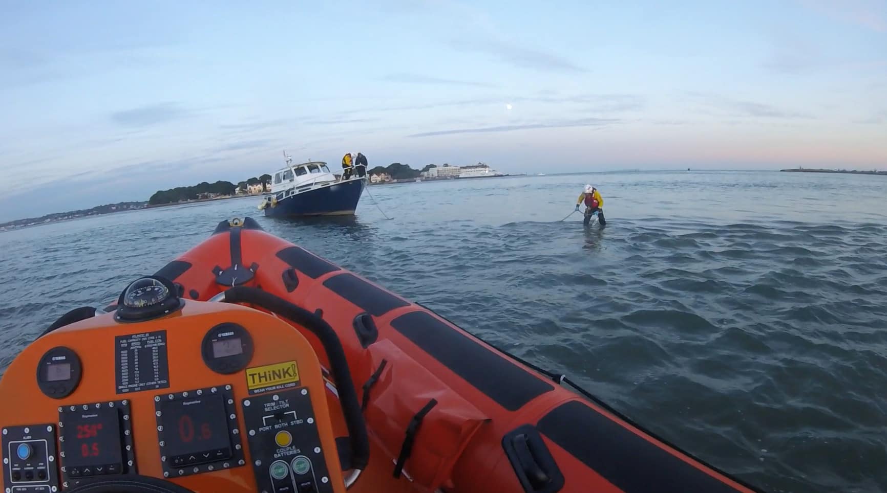 Crew members anchoring the aground boat. Photo: RNLI.