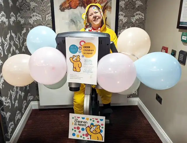 Upton Bay staff member Karen as Pudsey gets on her bike