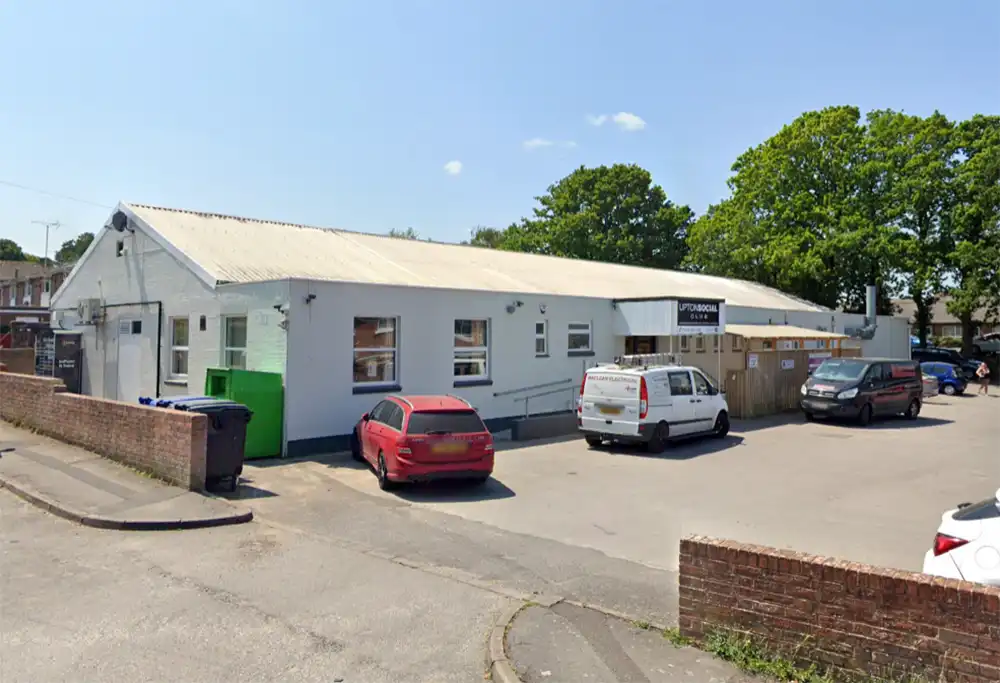 The man, in his 60s, was found outside Upton Social Club, in Poole Road. Picture: Google