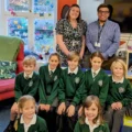Corfe Castle Primary School headteacher Amy Howe, back left, with deputy Robert Stoner and pupils