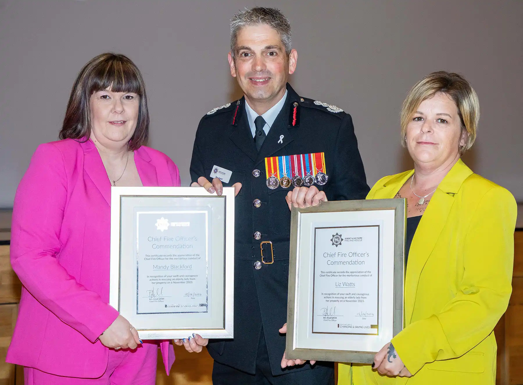 Mandy Blackford and Liz Watts receive their award from CFO Ben Ansell. Picture: DWFRS