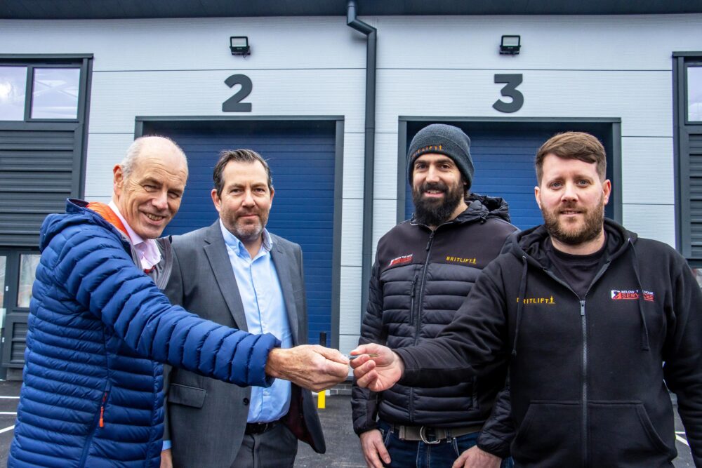 Cllr Richard Biggs hands over the keys to Liam Botting, managing director and Anthony Culshaw, technical director at Britlif, joined by Justin Ives, managing director, Spetisbury Construction who built the units Picture: Dorset Council